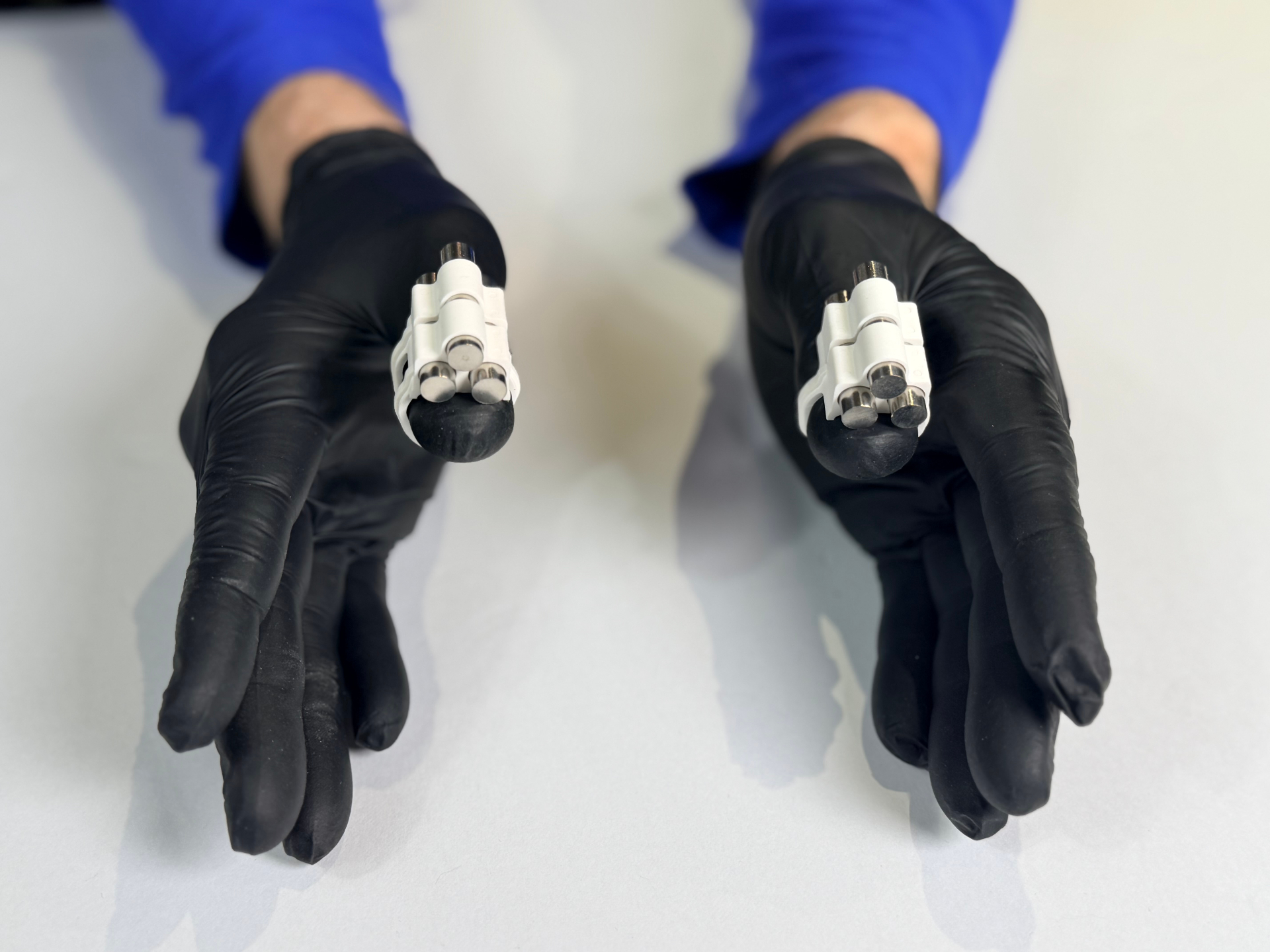 Hands wearing FingerWeights demonstrating progressive resistance training